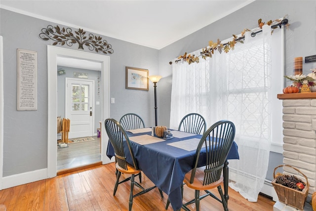 dining room featuring crown molding and wood-type flooring