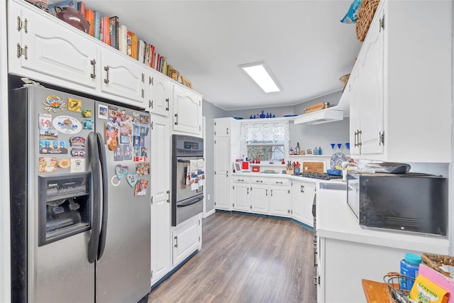 kitchen featuring white cabinets, dark hardwood / wood-style floors, stainless steel appliances, and exhaust hood