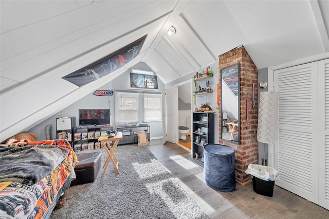 bedroom featuring wood-type flooring and vaulted ceiling