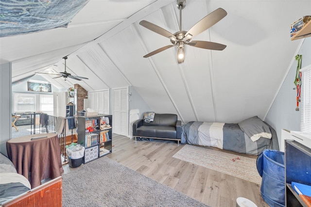 bedroom featuring ceiling fan, lofted ceiling, and light hardwood / wood-style flooring