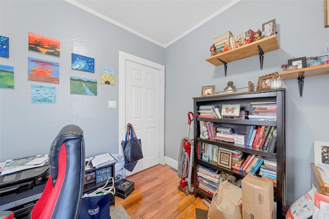 home office featuring light hardwood / wood-style flooring and crown molding