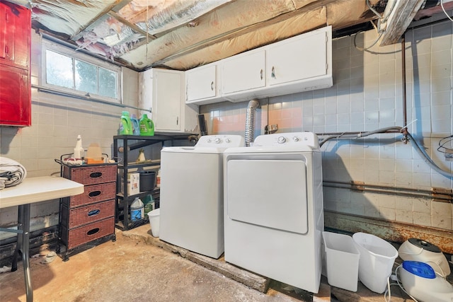 washroom featuring cabinets and washer and dryer