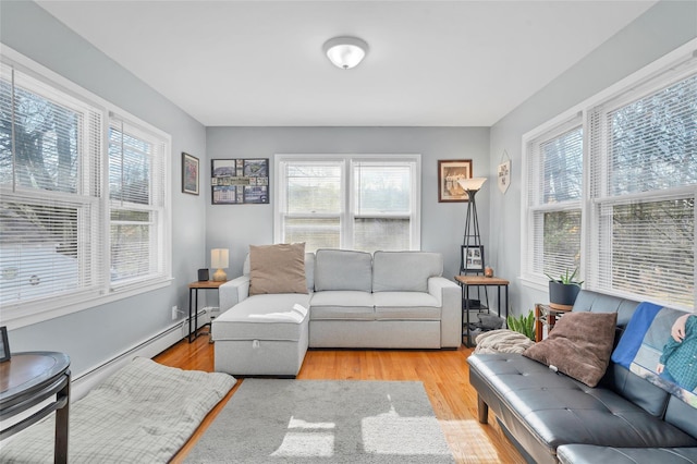 living room with light hardwood / wood-style flooring, a healthy amount of sunlight, and a baseboard radiator