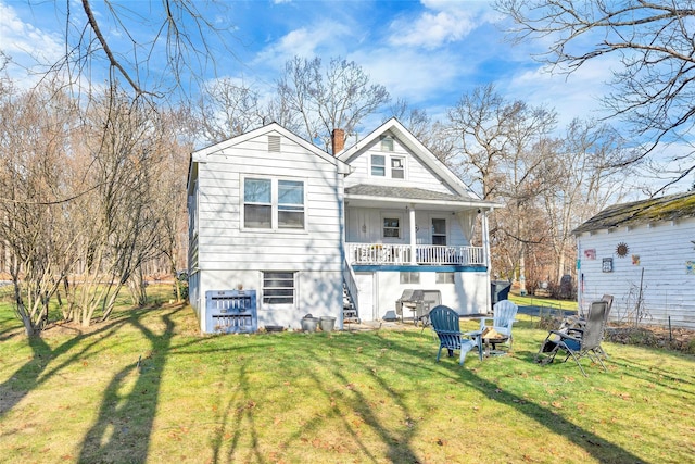 rear view of property with a lawn