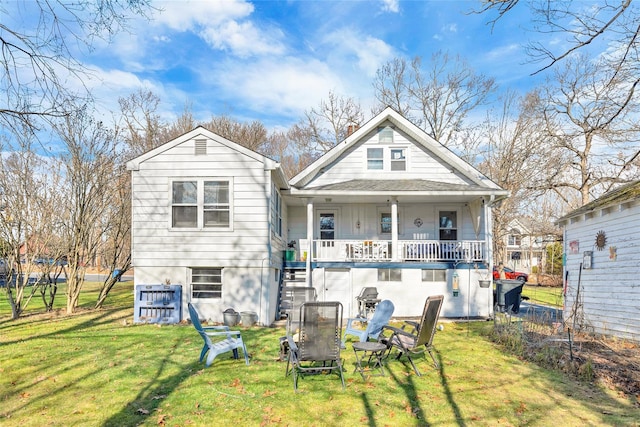 back of house featuring a lawn and a porch