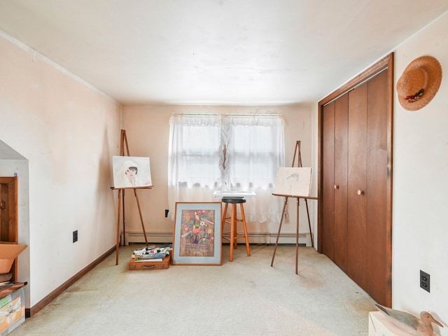 misc room with light carpet and a baseboard heating unit