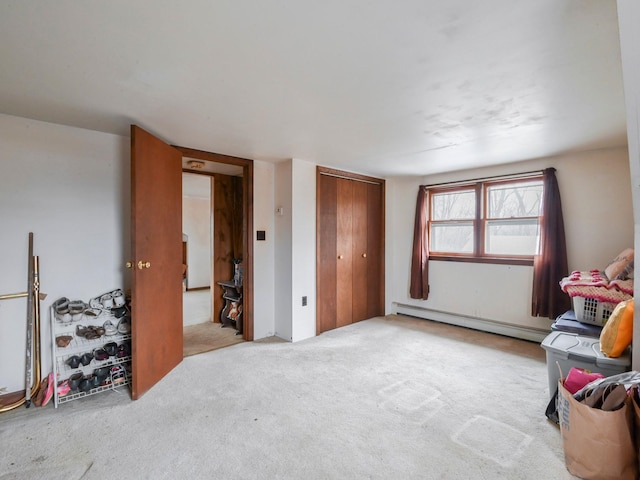 interior space featuring light colored carpet and baseboard heating