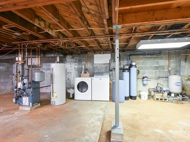 989 State Route 17k, Montgomery, NY 12549 - unfinished basement featuring water heater, a water pressure tank, washing machine and clothes dryer, a heating unit, and a water softener system