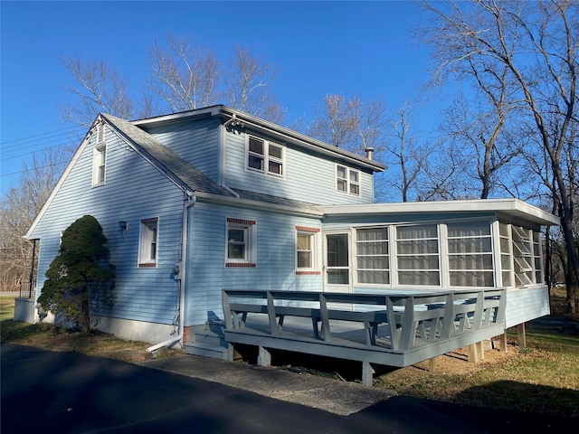 989 State Route 17k, Montgomery, NY 12549 - back of house with a sunroom, a wooden deck, and a shingled roof