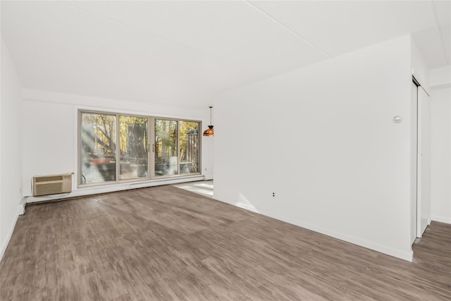 unfurnished living room with a wall mounted AC and hardwood / wood-style flooring