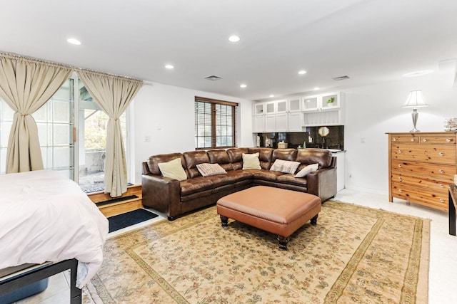 living area featuring recessed lighting and visible vents