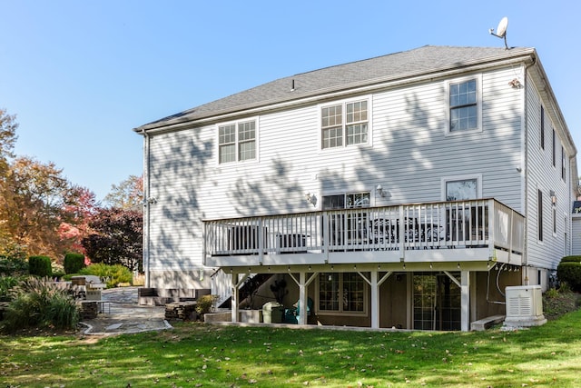 back of house featuring a patio area, a wooden deck, and a yard