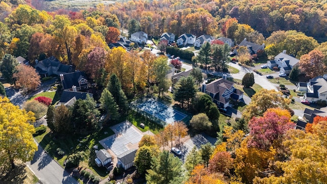 bird's eye view with a wooded view and a residential view