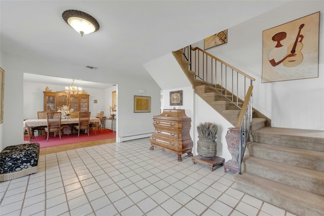 stairs with a notable chandelier and tile patterned floors