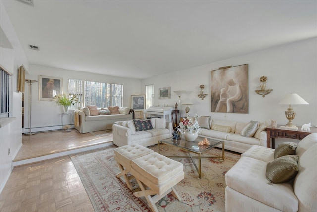 living room featuring a baseboard heating unit and light parquet flooring