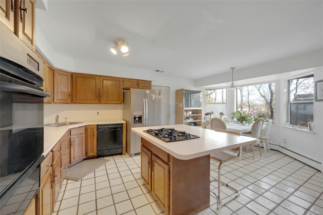 kitchen featuring sink, a center island, a breakfast bar area, hanging light fixtures, and black appliances