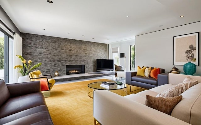 living room featuring a fireplace and a healthy amount of sunlight