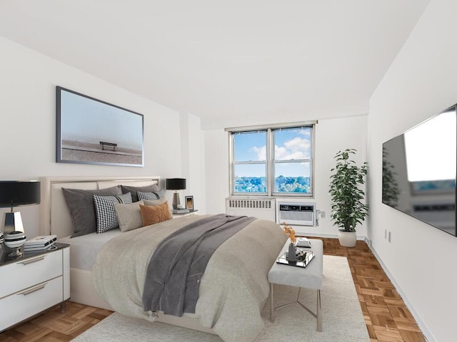 bedroom featuring parquet floors, radiator, and a wall mounted AC