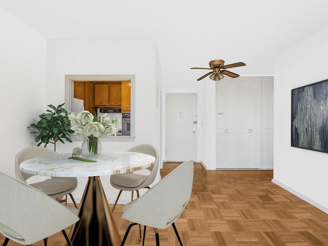 dining area featuring ceiling fan and light parquet floors