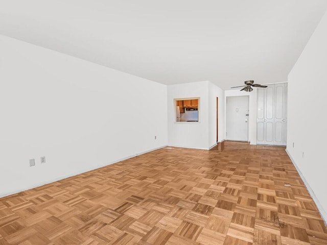 unfurnished room with light parquet flooring and ceiling fan