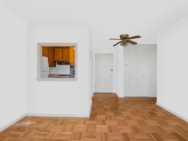 unfurnished living room featuring ceiling fan and light parquet floors