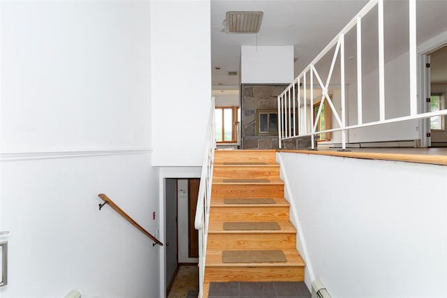 stairway with tile patterned floors