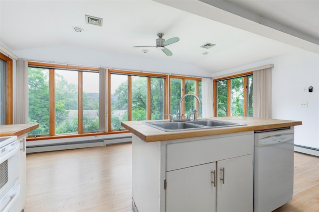 kitchen with dishwasher, plenty of natural light, white cabinetry, and vaulted ceiling