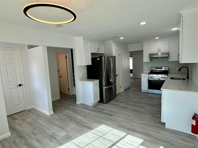 kitchen featuring sink, light wood-type flooring, a baseboard radiator, white cabinetry, and stainless steel appliances