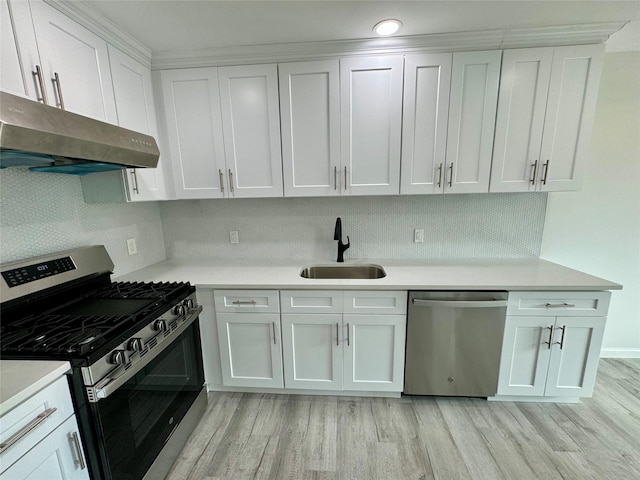 kitchen featuring light wood-type flooring, white cabinetry, sink, and appliances with stainless steel finishes