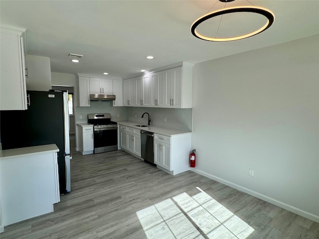 kitchen featuring white cabinets, stainless steel appliances, light hardwood / wood-style floors, and sink