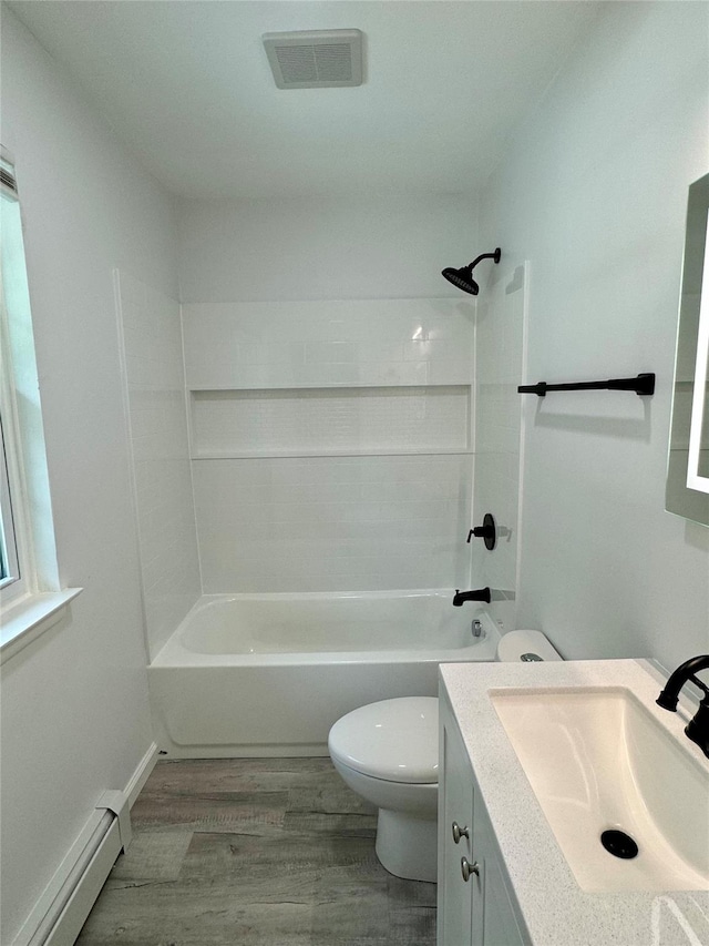 full bathroom with vanity, hardwood / wood-style flooring, toilet, a baseboard radiator, and shower / bathtub combination