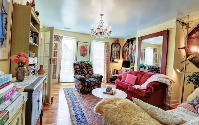 living room featuring light hardwood / wood-style floors and an inviting chandelier