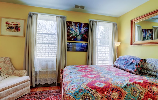 bedroom with hardwood / wood-style flooring