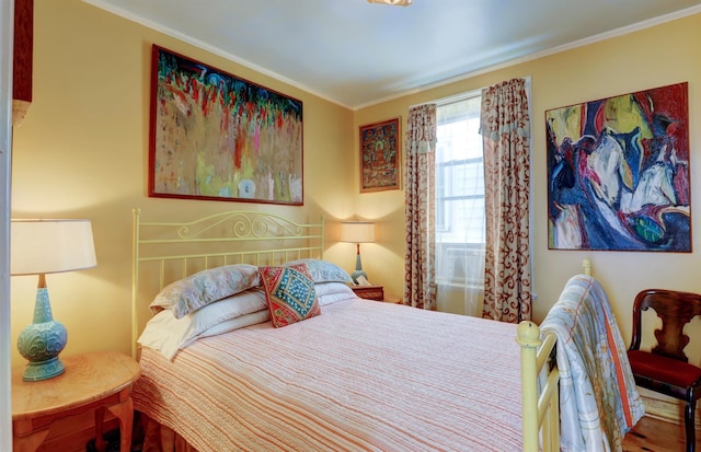 bedroom featuring hardwood / wood-style flooring and ornamental molding