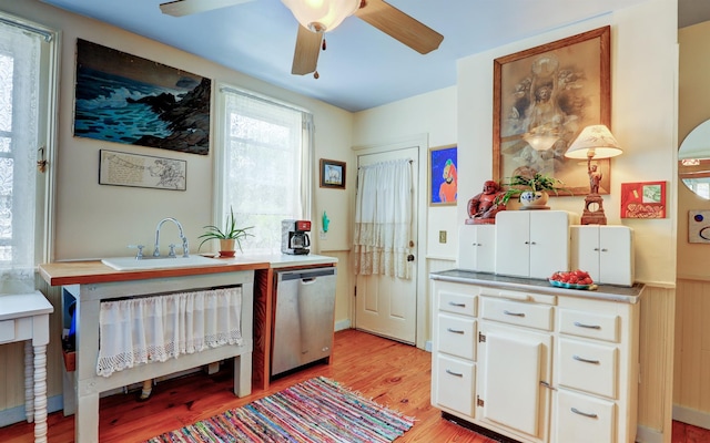 kitchen with dishwasher, sink, white cabinets, ceiling fan, and light hardwood / wood-style floors