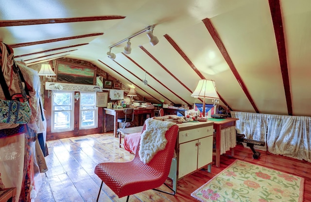 bedroom featuring lofted ceiling with beams and light wood-type flooring