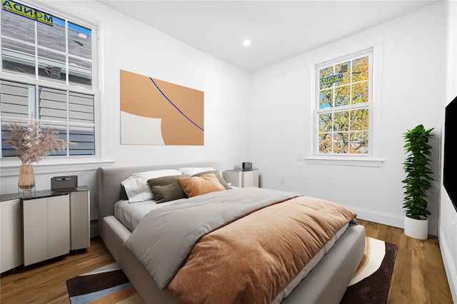 bedroom with dark wood-type flooring