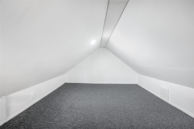 bonus room featuring carpet floors and vaulted ceiling