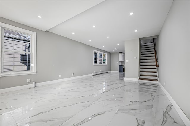 unfurnished living room featuring a baseboard heating unit