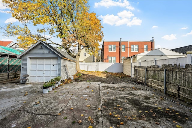 view of yard featuring a garage and an outbuilding