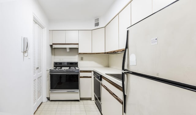 40 Brighton 1st Rd Unit 3J, Brooklyn, NY 11235 - kitchen with white appliances, white cabinetry, light countertops, and under cabinet range hood