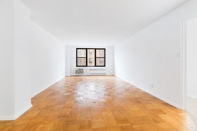 40 Brighton 1st Rd Unit 3J, Brooklyn, NY 11235 - unfurnished room with radiator heating unit, a wall mounted air conditioner, and baseboards
