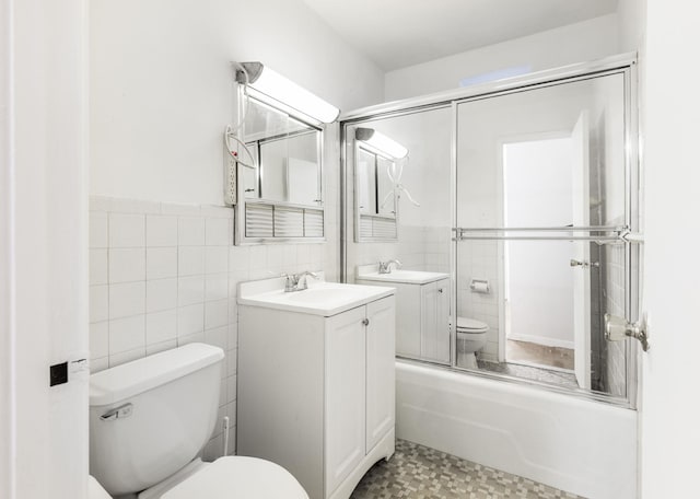 40 Brighton 1st Rd Unit 3J, Brooklyn, NY 11235 - full bathroom with toilet, vanity, tile walls, combined bath / shower with glass door, and wainscoting