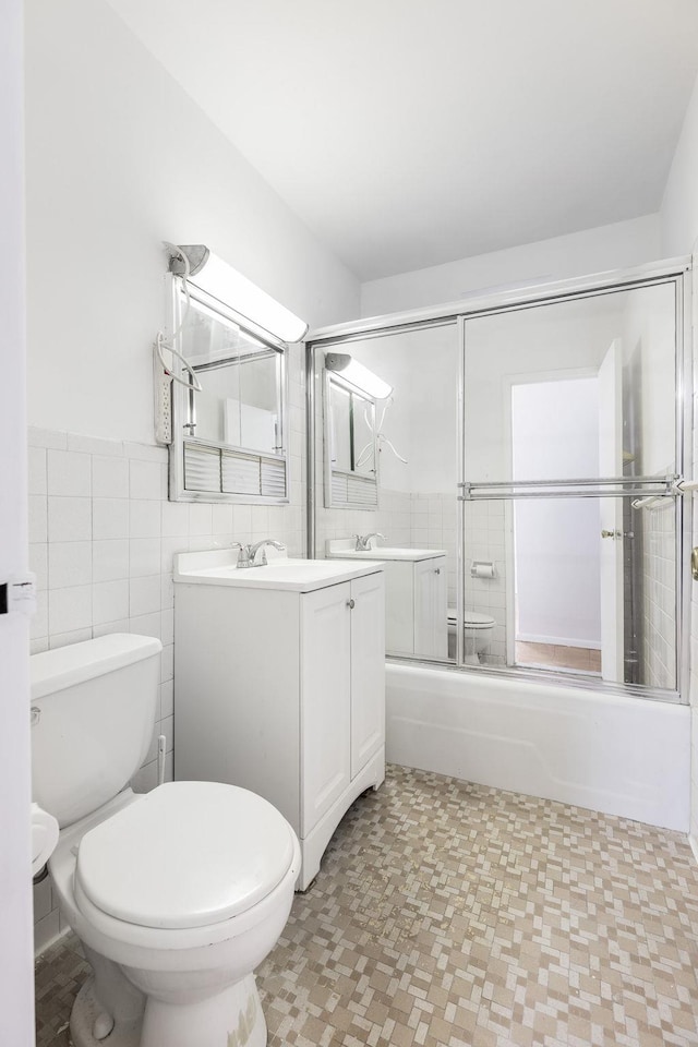 40 Brighton 1st Rd Unit 3J, Brooklyn, NY 11235 - full bath with vanity, toilet, enclosed tub / shower combo, tile walls, and tile patterned floors