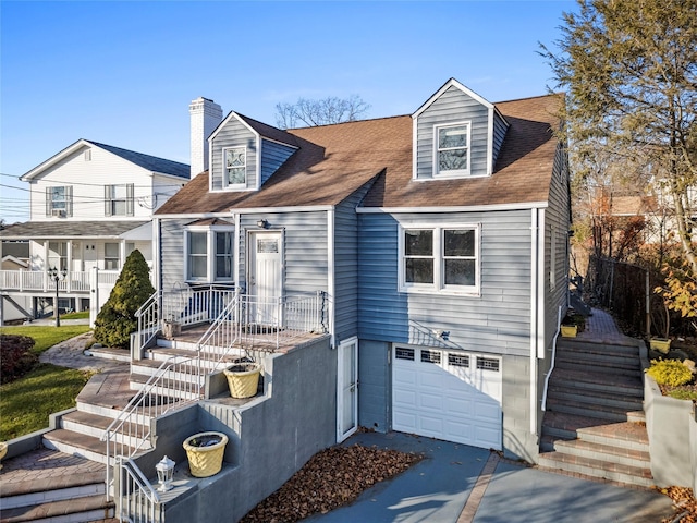 cape cod home with a garage