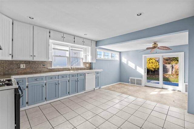 kitchen featuring white cabinets, plenty of natural light, ceiling fan, and white appliances