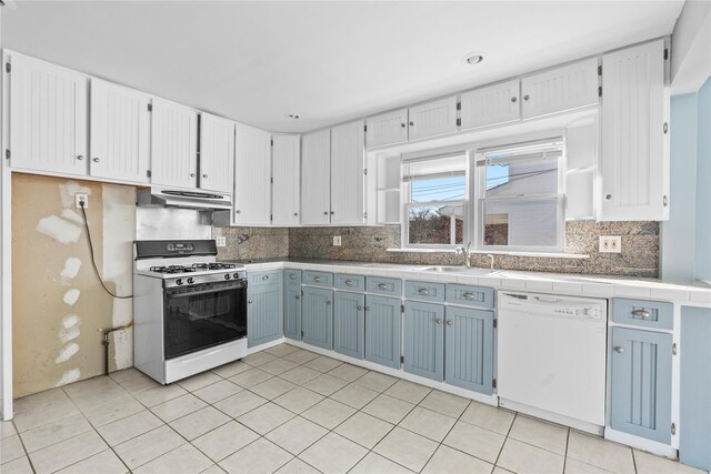 kitchen featuring white cabinetry, sink, and white appliances