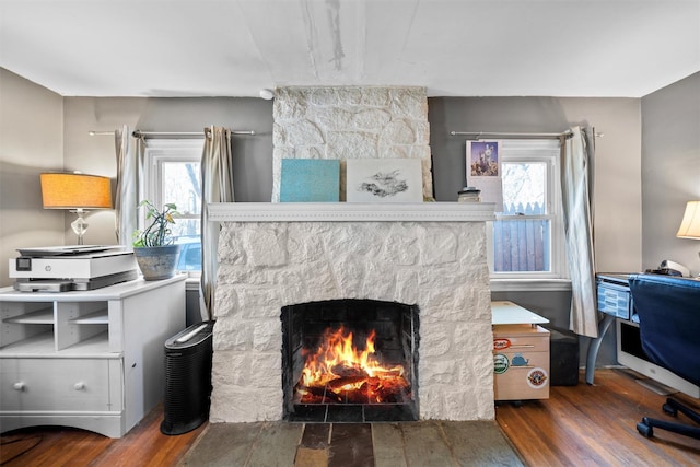 interior space featuring hardwood / wood-style flooring and a stone fireplace