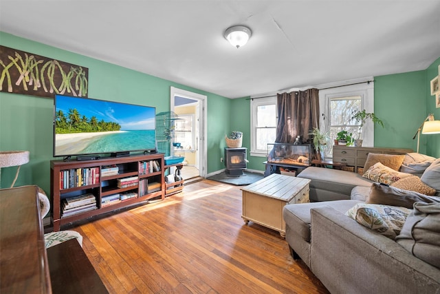 living room with wood-type flooring and a wood stove