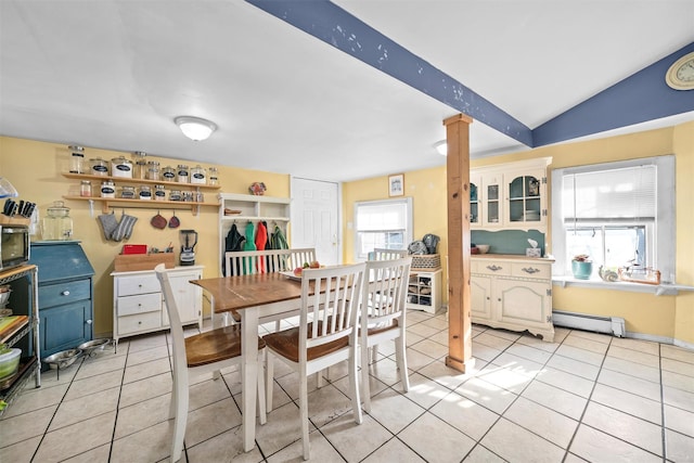 tiled dining area featuring baseboard heating, decorative columns, a healthy amount of sunlight, and vaulted ceiling